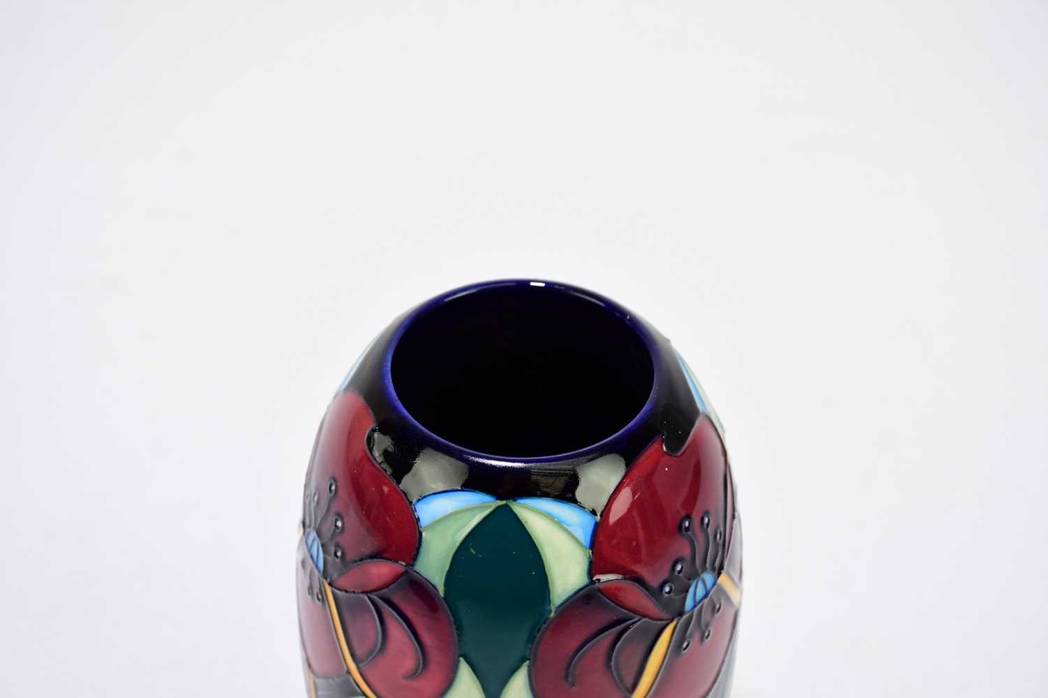 RACHEL BISHOP FOR MOORCROFT; a vase deorated with stylised flowers against a green goround, height - Image 2 of 4