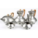 TUDRIC PEWTER; an Arts and Crafts five piece tea service with planished decoration (5).