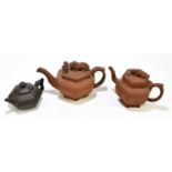 Two Chinese redware Yixing type teapots and covers, of octagonal form, two with Shishi finials,