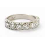 A platinum seven stone diamond set half eternity ring, set with seven round brilliant cut stones,