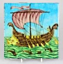 WILLIAM DE MORGAN; an Art Pottery tile painted with a galleon with five sailors, each with paddles
