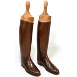 A pair of of tan leather riding boots, with three section boot trees, height 57cm, length of sole