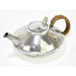 ARCHIBALD KNOX FOR ENGLISH PEWTER; a Liberty & Co pewter teapot of squat circular form, embossed