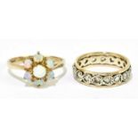 A 9ct yellow gold and opal floral cluster ring, size L 1/2, and a 9ct eternity ring, size J,