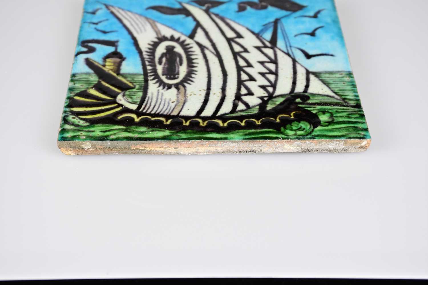 WILLIAM DE MORGAN; an Art Pottery tile painted with a two masted ship in shades of black, white, - Image 3 of 6