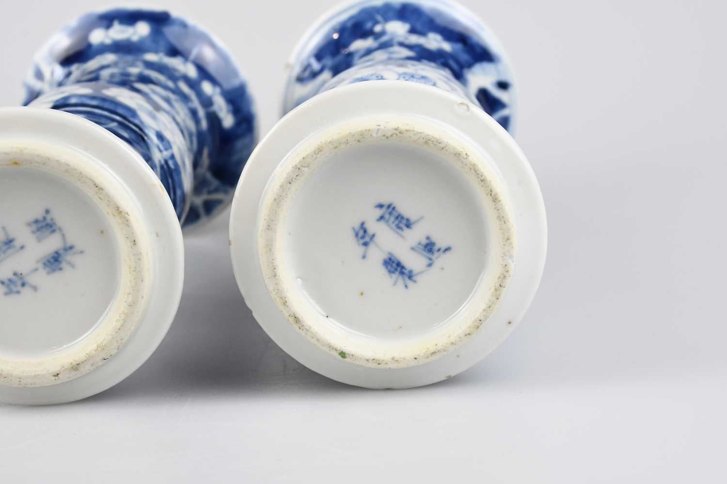 A pair of late 19th century Chinese blue and white porcelain Gu vases painted with prunus flowers on - Image 4 of 5