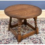 A reproduction Old Charm oak circular top coffee table, height 46cm, diameter of top 60cm.