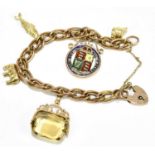 A 9ct yellow gold charm bracelet suspending an enamelled Victorian charm, fish charm, citrine swivel