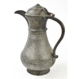 An 18th/19th century Persian bronzed metal ewer decorated throughout with foliate and floral panels,