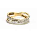 A 9ct yellow gold diamond set crossover ring, size L 1/2, approx. 3.1g.