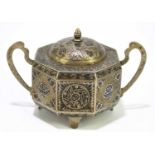 A Persian white metal octagonal box with hinged cover niello decorated with floral detail, width