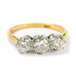 An 18ct yellow gold diamond set three stone dress ring, set with three round brilliant cut diamonds,