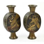 A pair of Japanese bronzed metal vases, each decorated in gilt with peacocks and exotic birds,