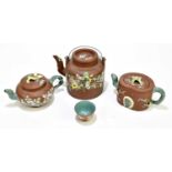 Three Chinese redware Yixing teapots and covers, with green enamel foliate detailing, tallest