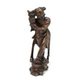 A Japanese carved root wood figure of a male holding a vase, height 29cm.