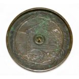 A 19th century Chinese bronze mirror, cast with a fence and foliage, diameter 11.5cm.