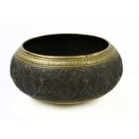 An Eastern bronze bowl of large proportions with cental exterior band depicting stylised figures and