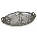 WMF; a pewter dish of oval form relief decorated with a girl on her knees gazing at a snail,