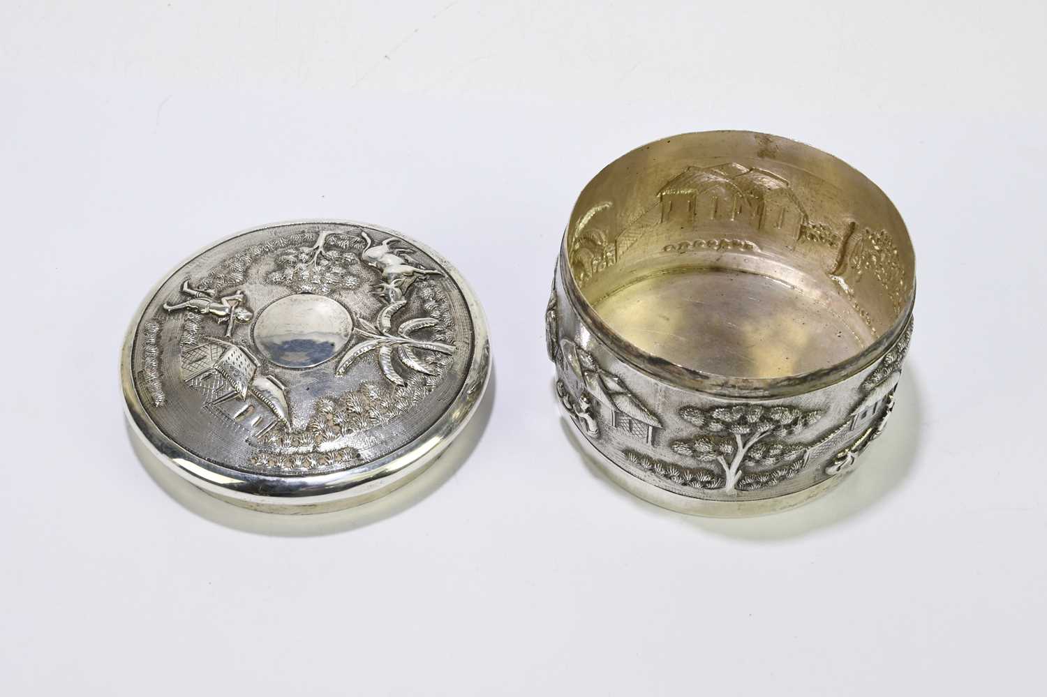 An Indian white metal lidded trinket box, decorated with village scenes. - Image 5 of 5