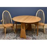 ERCOL; a set of four ash and beech dining chairs, including two arms, with solid seat on turned