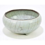 A Chinese crackle glazed circular bowl with three moulded feet, diameter 22cm. Condition Report: