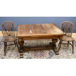 A 1920s oak draw leaf table, with five wheel back chairs, table height 70cm, length 170cm, width
