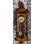A large Victorian Vienna walnut and mahogany wall clock, the painted dial set with Roman numerals,