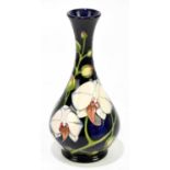 PHILIP GIBSON FOR MOORCROFT; a limited edition vase of baluster form with floral sprays on a blue