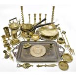 A collection of brass wares to include four saucepans with wrought iron handles, two pairs of