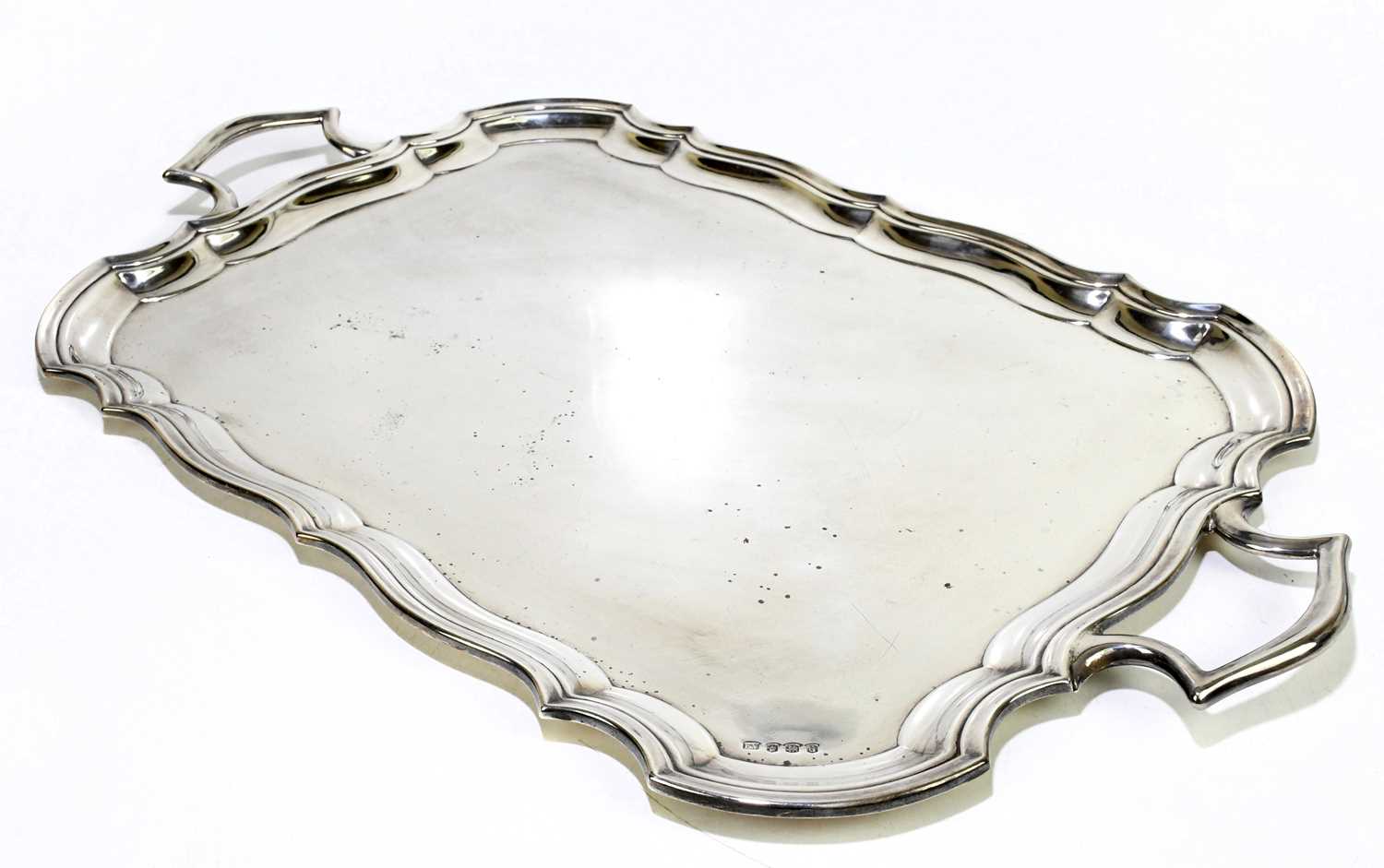 VINERS LTD; a George V hallmarked silver twin handled serving tray, of serpentine rectangular
