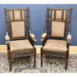 A pair of Victorian carved oak hall chairs, the rectangular backs with bobbin turned uprights, above