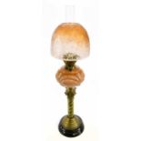 A late Victorian oil lamp, the cloudy glass reservoir with opaque detail and frosted glass shade,