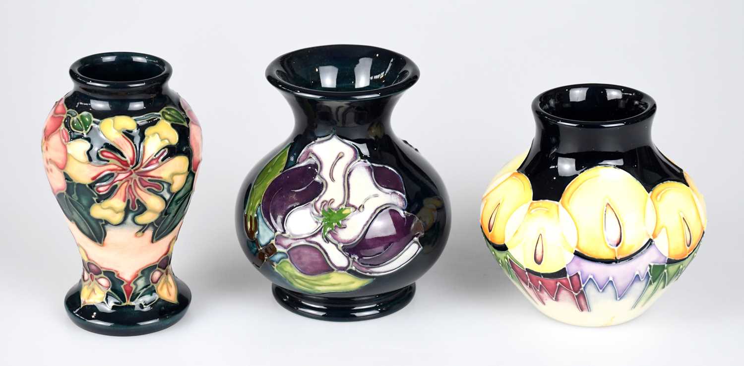 MOORCROFT; three small vases, including an example decorated in the 'Oberon' pattern, height 10cm.