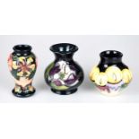 MOORCROFT; three small vases, including an example decorated in the 'Oberon' pattern, height 10cm.