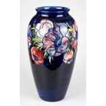 WALTER MOORCROFT; a large 'Anemone' pattern vase, decorated with flowers against a blue ground,