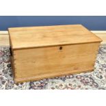 A late Victorian pine blanket box, with hinged lid, on moulded base, height 42cm, width 92cm,