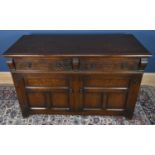 A carved oak sideboard with two drawers over two cupboards, on square feet, width 137cm, height