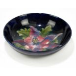 MOORCROFT; a 'Columbine' pattern bowl, the centre decorated with a central flower and leaves against