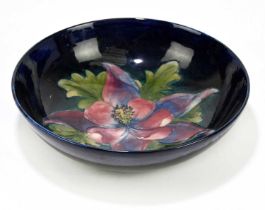MOORCROFT; a 'Columbine' pattern bowl, the centre decorated with a central flower and leaves against