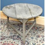 A 19th century pine cricket table on later castors, diameter 80cm, height 58cm.