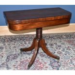 A Regency mahogany fold over card table, with turned column on reeded legs, height 71cm, width