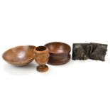 Two modern turned wooden bowls, together with a turned wooden pot and two book ends modelled as