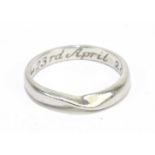 A platinum wedding band of swept design, size K 1/2, approx. 4.2g.