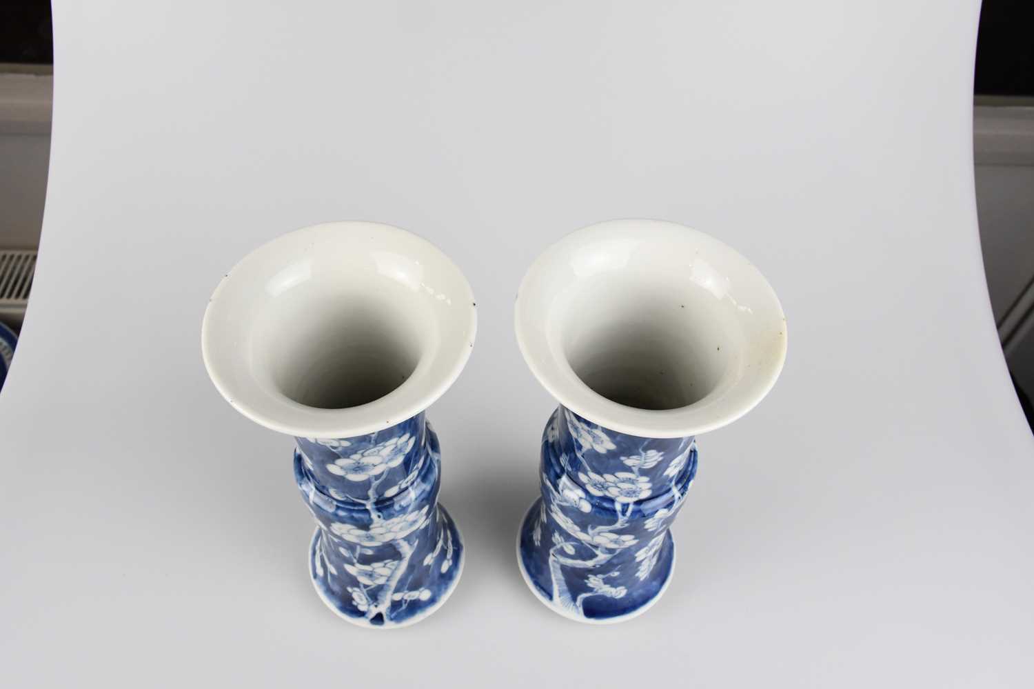 A pair of late 19th century Chinese blue and white porcelain Gu vases painted with prunus flowers on - Image 2 of 5