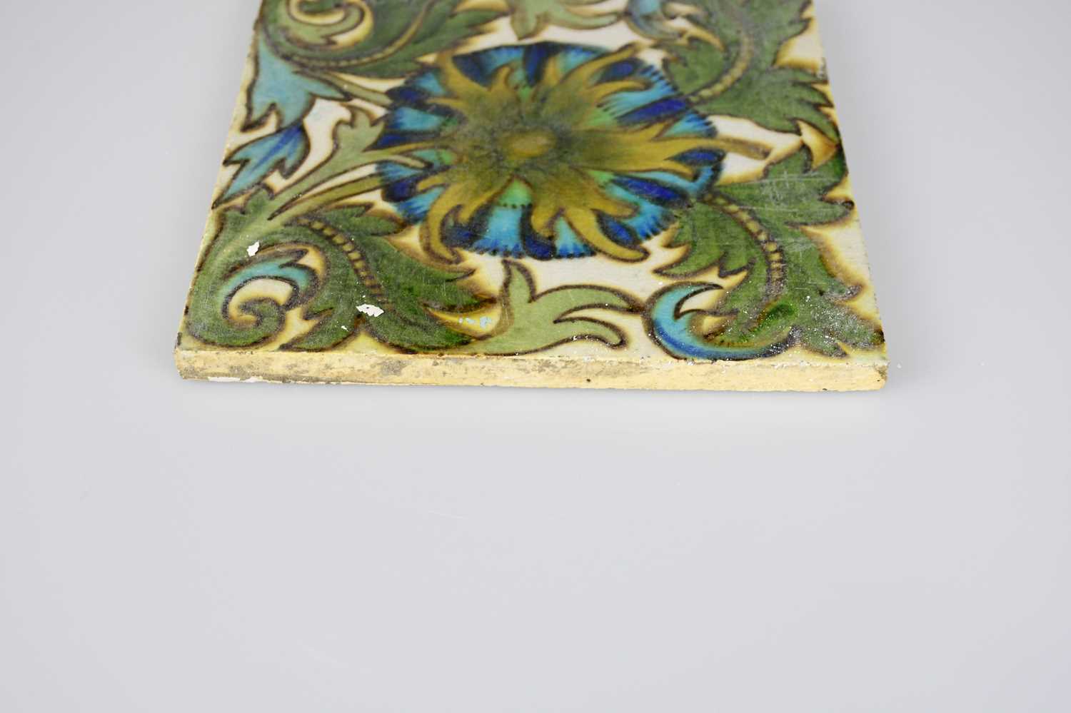 ATTRIBUTED TO MAW & CO; an Art Pottery tile painted with floral decoration, in shades of green, - Image 6 of 6