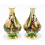 JOSEPH HADLEY FOR ROYAL WORCESTER; a pair of hand painted vases of baluster form, decorated with