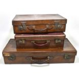 Three vintage leather suitcases, one inscribed 'L.W.N.F' (3).