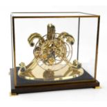CHARLES FRODSHAM; a brass skeleton clock, with single fusee movement, on oval base, within brass