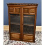 A 19th century bookcase with twin glazed doors, height 121cm, width 90cm, depth 29cm.