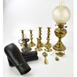 A brass oil lamp with frosted glass shade, together with a selection of candlesticks, two leather